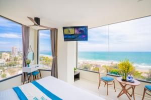 a bedroom with a bed and a view of the ocean at Annata Beach Hotel in Vung Tau