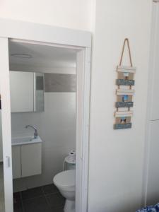 a bathroom with a toilet and a sink at Ofir, nice small unit, 123Eilat in Eilat