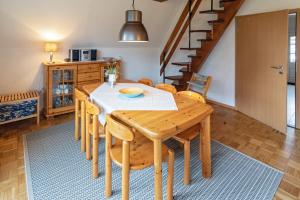 eine Küche und ein Esszimmer mit einem Holztisch und Stühlen in der Unterkunft Ferienhaus Seestern in Dornumersiel