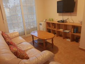 a living room with a couch and a table at Nice apartment with spacious terrass and rooftop in Los Alcázares