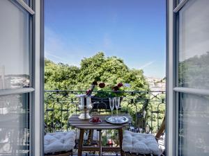 a balcony with a table with a view of the city at Residentas Sao Pedro in Lisbon