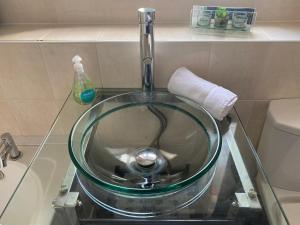 a glass sink with a faucet in a bathroom at Recently Furnished Stylish 3 Bed House by Town and Beach in Blythe +25 photos