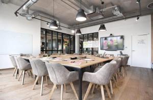 a large conference room with a large table and chairs at Coloft in Lesquin