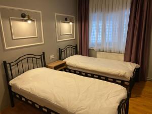 two twin beds in a room with a window at Sea View and Veranda apart in sultanahmet in Istanbul