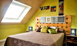 ein Schlafzimmer mit einem Bett mit gelben Wänden und einem Fenster in der Unterkunft Ty an Aod in Kerlaz