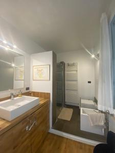 a bathroom with a large white sink and a shower at CASA SANDRA in Crema