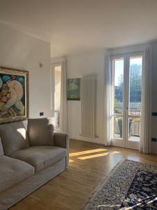 a living room with a couch and a large window at CASA SANDRA in Crema