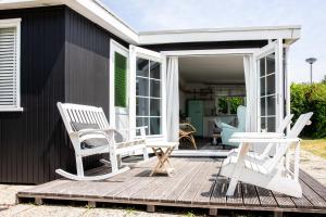 een terras met 2 stoelen en een tafel bij Strand-chalet Luna - 700 mtr van het strand van Ouddorp in Ouddorp