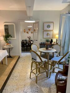 a living room with a table and chairs at L'Ancienne Boulangerie in Caunes-Minervois