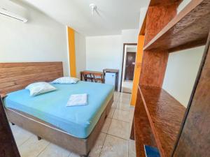 Säng eller sängar i ett rum på Pousada Estrela Dourada