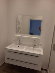 a white bathroom with a sink and a mirror at Exklusive FW mit 3 SZ und großer Terrasse in Gratkorn +58 photos