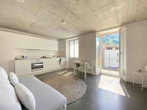 a living room with a bed and a kitchen at Casa Vino e Birra in Osogna