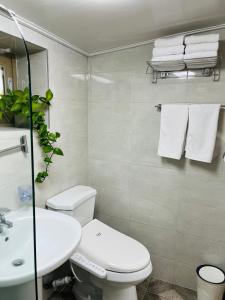 a bathroom with a white toilet and a sink at Jeju Time in Jeju