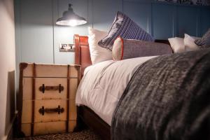 a bedroom with a bed with pillows and a night stand at Greswolde Arms by Chef & Brewer Collection in Solihull