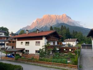 a house with a mountain in the background at Appartement Wilhelm in Ehrwald