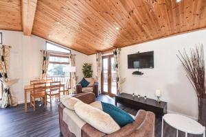 a living room with a couch and a table at #2 Delightful 3 bedroom holiday lodge no hot tub 