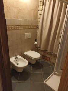 a bathroom with a toilet and a sink at Ca' de Baci' du Mattu in Mendatica