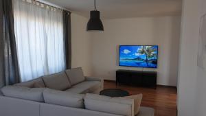 a living room with a couch and a flat screen tv at Apartment Belvedere in Kraljevica