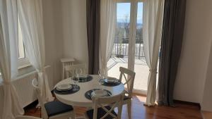 a white table and chairs with a view of a balcony at Apartment Belvedere in Kraljevica
