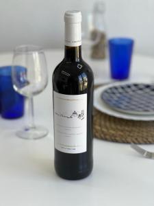 a bottle of wine sitting on a table with a glass at Apartamento Esperanza by Altea Blanca Apartamentos Turísticos in Altea