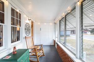 a porch with a chair and a desk and windows at Shenandoah Getaway Near National Park Cozy Space! in Shenandoah