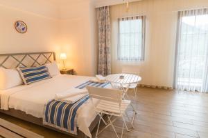 a bedroom with a bed and a table and chairs at Mavi Deniz Konuk Evi in Selimiye +47 photos