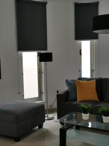 a living room with a couch and a table at City Flats 308 in Larnaca +10 photos
