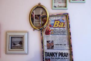 a mirror hanging on a wall with a newspaper at Art Hostel in Leeds