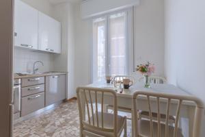 - une cuisine avec une table, des chaises et un évier dans l'établissement a 500 mt dalla Certosa Apartment, à Bologne