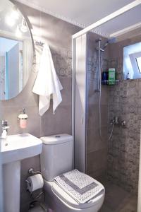 a bathroom with a toilet and a sink and a shower at House with Yard by the Hill in Athens +4 photos