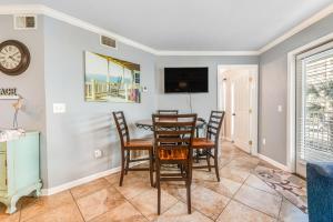 a dining room with a table and chairs at Summer Breeze 21 in Orange Beach