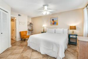 a bedroom with a white bed and a ceiling fan at Summer Breeze 21 in Orange Beach +19 photos
