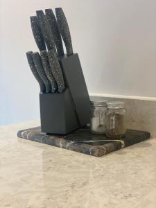 a black knife block sitting on top of a counter at Icona - Stylish apartment in brand new development! in York