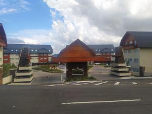 a parking lot with a building with a sign on it at GOLDEN GRAMADO RESORT in Gramado