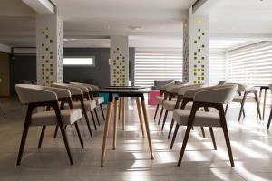 a dining room with a table and chairs at Flora Maria Hotel in Ayia Napa