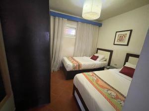 A bed or beds in a room at Amazing view apartment in Golf Porto Marina with marina access