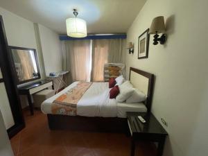 A bed or beds in a room at Amazing view apartment in Golf Porto Marina with marina access