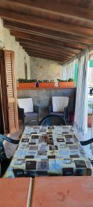 a table in a living room with a fireplace at Villa Elisa Chia Su Giudeu in Domus de Maria