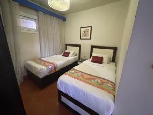 A bed or beds in a room at Amazing view apartment in Golf Porto Marina with marina access
