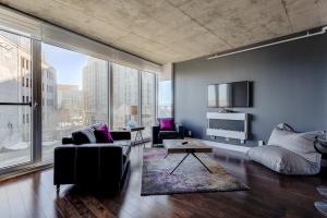 a living room filled with furniture and a large window at Les Immeubles Charlevoix - Le 760310 in Quebec City