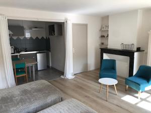 a living room with a couch and chairs and a table at A2 PAS in Lectoure