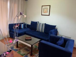 A seating area at Amazing view apartment in Golf Porto Marina with marina access