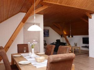 a dining room with a wooden table and chairs at Penzion Stranny in Stranný