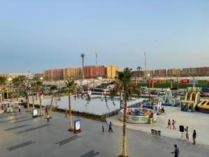 a group of people walking around a water park at Amazing view apartment in Golf Porto Marina. in El Alamein