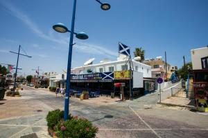 a street with a building on the side of a street at Flora Maria Hotel in Ayia Napa