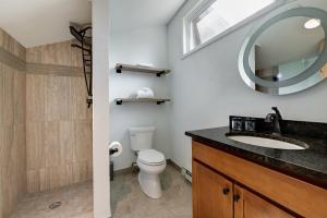 a bathroom with a toilet and a sink and a mirror at Inner Circle 15 Serenity Condo Great Breck Location in Breckenridge +16 photos