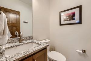 a bathroom with a sink and a toilet at Deere Retreat Home: Hot Tub, Stylish in Overlook Athletic Club Heliport +29 photos