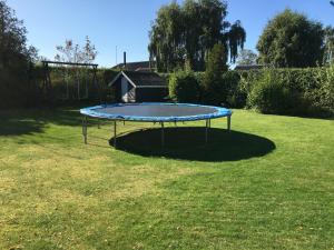 a trampoline in the grass in a yard at Hasmark beach, nice house close to the beach. in Otterup