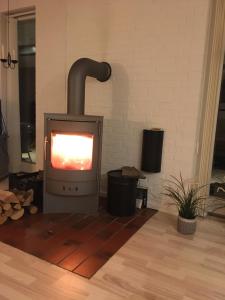 a stove in a room with a brick wall at Hasmark beach, nice house close to the beach. in Otterup