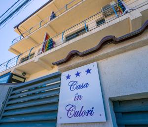a sign on the side of a building at Casa in Culori Vama Veche in Vama Veche